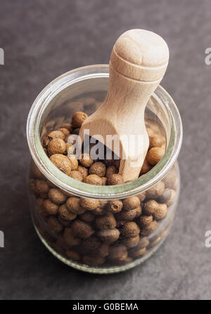 Allspice (jamaica pepper) berries texture, background full frame. Used as a spice in cuisines all over the world. The plant is a Stock Photo