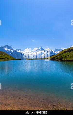 Stunning view of Bachalpsee and the snow coverd peaks with glacier of swiss alps, on Bernese Oberland, Switzerland. Stock Photo