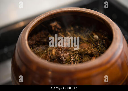 medicinal herbs in enamel pot close up Stock Photo