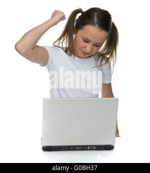Angry young girl attacking her laptop computer Stock Photo