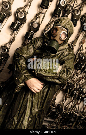 Photo of a man in WWII's clothes and gas mask Stock Photo