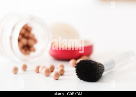 Composition of bronzing pearls and makeup brush horizontal Stock Photo