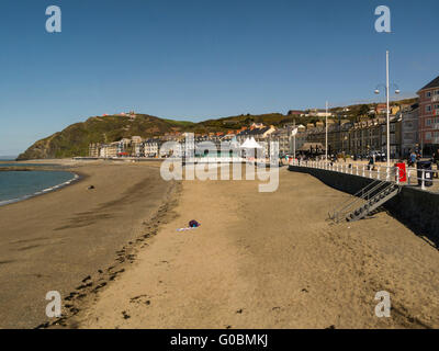 Looking along sandy beach of Aberystwyth sea front to Cliff Railway Ceredigion Mid Wales popular Welsh seaside town and public research University Stock Photo