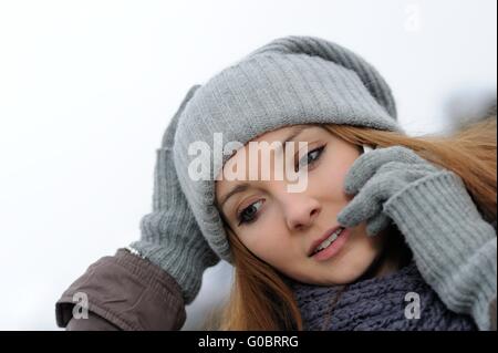 Young female with mobile wearing winter clothings Stock Photo