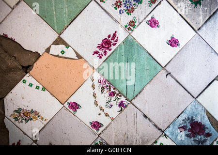 Surface of the old and partly damaged square tiles Stock Photo