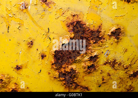 Yellow painted old metal surface with rust Stock Photo