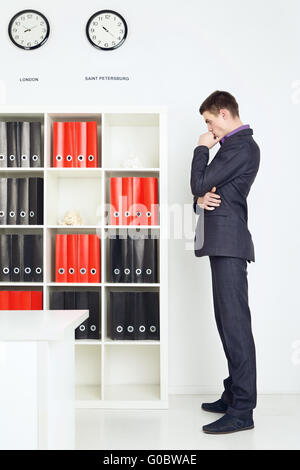 Young Businessman Lost In Thought Stock Photo