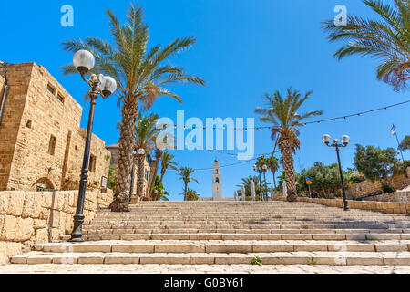 Lampposts and palms along stone stairs under blue sky in old town of Jaffa, Israel. Stock Photo