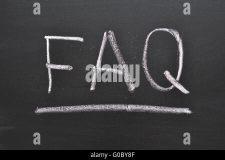 abbreviation FAQ handwritten on black chalkboard Stock Photo