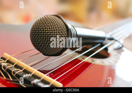 guitar and microphoneon the wooden dark background Stock Photo