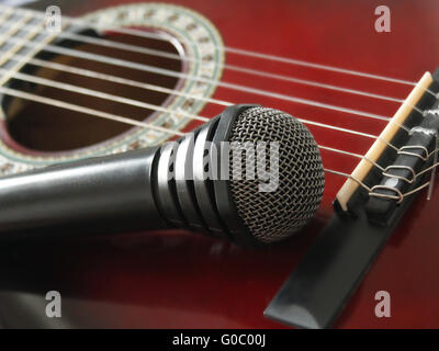 guitar and microphoneon the wooden dark background Stock Photo