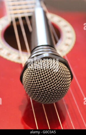 guitar and microphoneon the wooden dark background Stock Photo