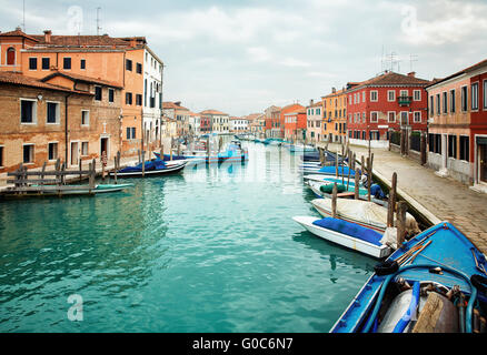 Narrow canal among old colorful houses on island of Murano Stock Photo