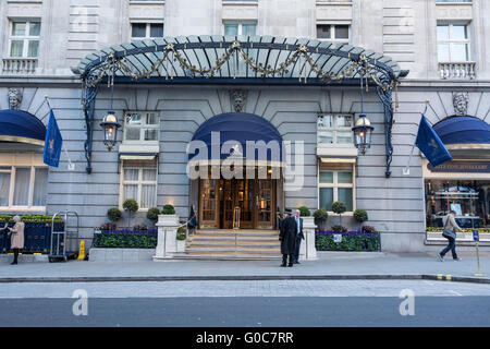 A concierge standing outside the entrance to world famous Ritz Hotel in Mayfair, central London, England, UK Stock Photo