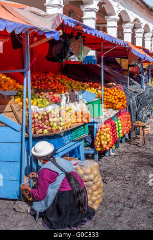 Woman crouching in front of her market stall in Ot Stock Photo