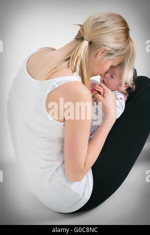 Portrait of a young mother and baby and a girl in her arms Stock Photo