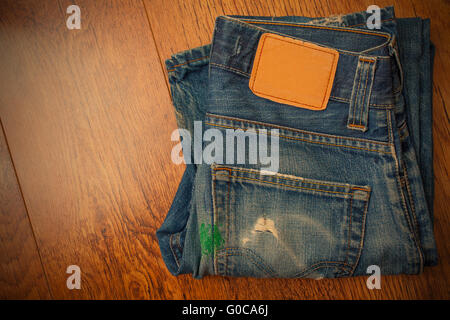 old blue jeans with brown label on the belt smeare Stock Photo