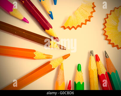 colored pencils and shavings on white background Stock Photo