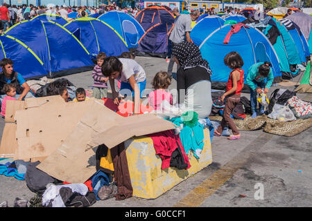Syrian refugee families prepare shelter from the elements while awaiting asylum processing in the harbor of Mytillene, Greece Stock Photo