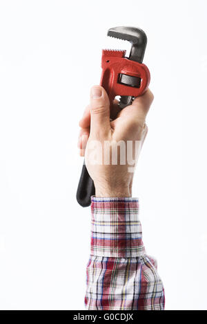 Male plumber's hand holding a pipe wrench on white background Stock Photo