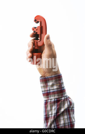 Male plumber's hand holding a pipe cutter on white background Stock Photo