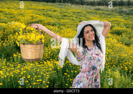 portrait of a happy girl in a field of yellow daisies Stock Photo