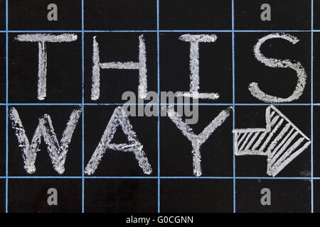 this way phrase handwritten on black chalkboard Stock Photo