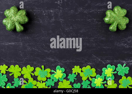 Green Clovers on Chalkboard Background Background for St. Patrick's Day Holiday Stock Photo