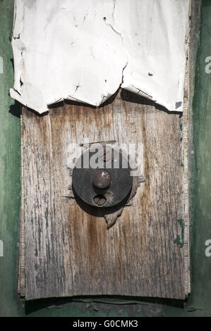 Old weathered grunge doorbell button on wooden pla Stock Photo