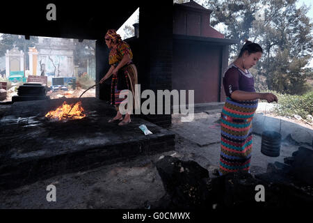 Local woman perform a traditional K'iche Maya ceremony using censers with smouldering incense at the cemetery in Chichicastenango also known as Santo Tomas Chichicastenango a town in the El Quiche department of Guatemala, known for its traditional Kiche Maya culture. Stock Photo