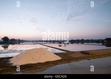 Early morning in salt field or salt farm in Sidoarjo, Indonesia. The traditional salt production called Petani Garam. Stock Photo