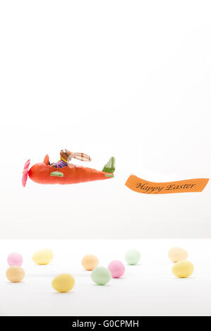 Easter bunny in a Carrot-Plane flying over Eggs Stock Photo