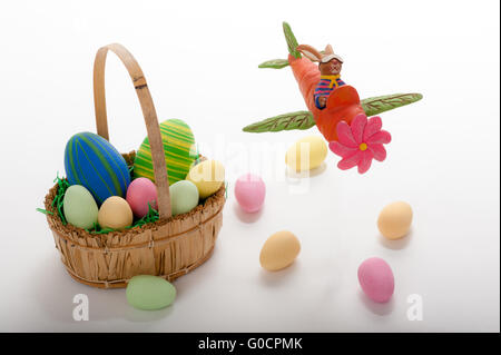 Easter bunny in a Carrot-Plane flying over Eggs Stock Photo