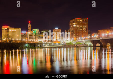 The skyline of downtown Hartford, Connecticut at dusk from across the Connecticut River. Stock Photo