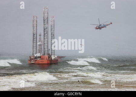Oil rig in a winter storm day during a violent blizzard.