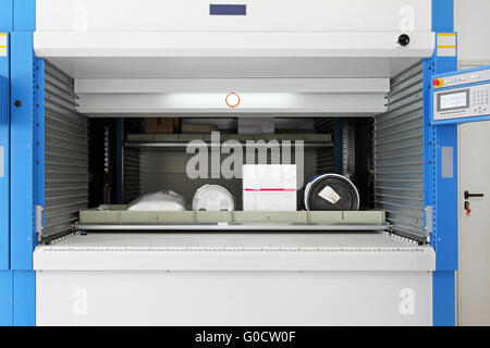 Open vertical carousel with tray goods in warehouse Stock Photo