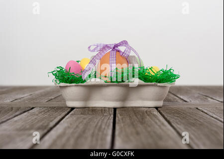 Easter Nest with eggs on a wooden table. Stock Photo