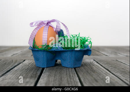 Egg in a easter nest on a table. Stock Photo