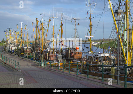 Fishing boats lie close together on the pier. Stock Photo