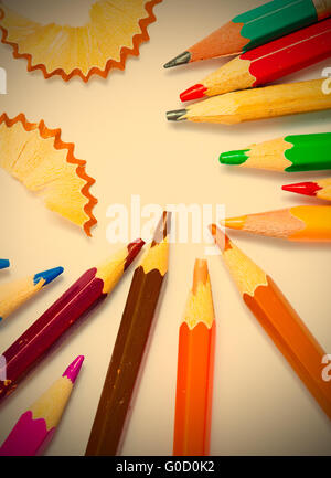 several colored pencils and shavings on white back Stock Photo
