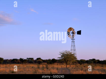 Windmill in desert Stock Photo