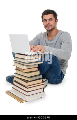 Young man looking for information in books and on the computer, isolated Stock Photo