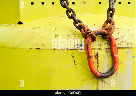 Red carabiner on yellow bottle Stock Photo