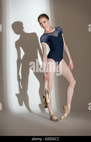 Full growth portrait of the graceful ballerina in a studio with Stock Photo