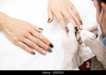 Master gets a new paint gray fingers on different Stock Photo