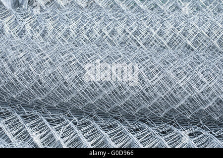 Rolled up metal galvanized fence nets closeup Stock Photo