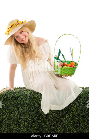 girl holding basket of colored eggs for easter Stock Photo