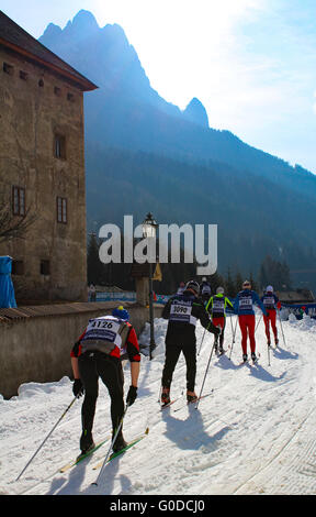 A procession of skiers compete in the Annual Marcialonga cross country skiing race in the Italian Dolomites Stock Photo