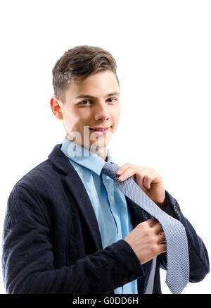 Teenager with tie getting dressed isolated on white background Stock Photo