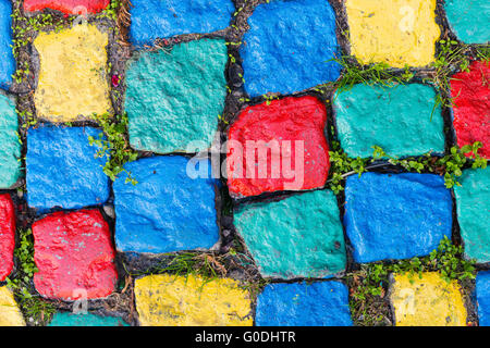 Old painted cobblestone background with grass Stock Photo
